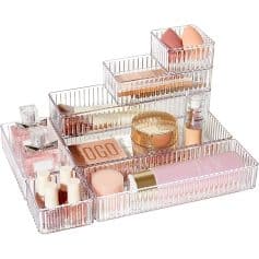 Elegant clear acrylic makeup organizer with multiple compartments for cosmetics, skincare, and beauty essentials, ideal for vanity or bathroom storage.