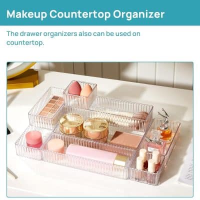 Clear acrylic makeup storage box with multiple compartments for organizing cosmetics, skincare, and beauty tools on a white countertop. Perfect for beauty enthusiasts and makeup lovers.