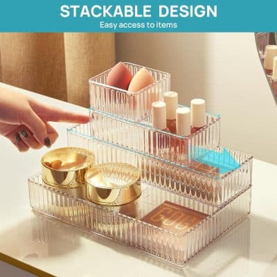 Transparent acrylic storage box with multiple compartments for organizing beauty and skincare products, featuring easy-access stackable design for makeup and cosmetic items.