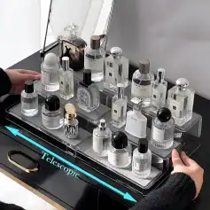 Luxurious perfume bottles arranged on a mirrored tray with an illuminated 