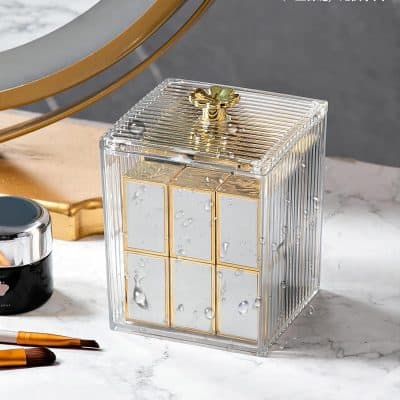 Luxurious perfume bottle with a clear acrylic exterior, gold accents, and water droplets, perfect for enhancing beauty and skincare routines at Monalisa Store.