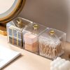 Clear acrylic storage containers with gold handles for contact lens solutions and accessories, ideal for optometry clinics and eyewear storage.