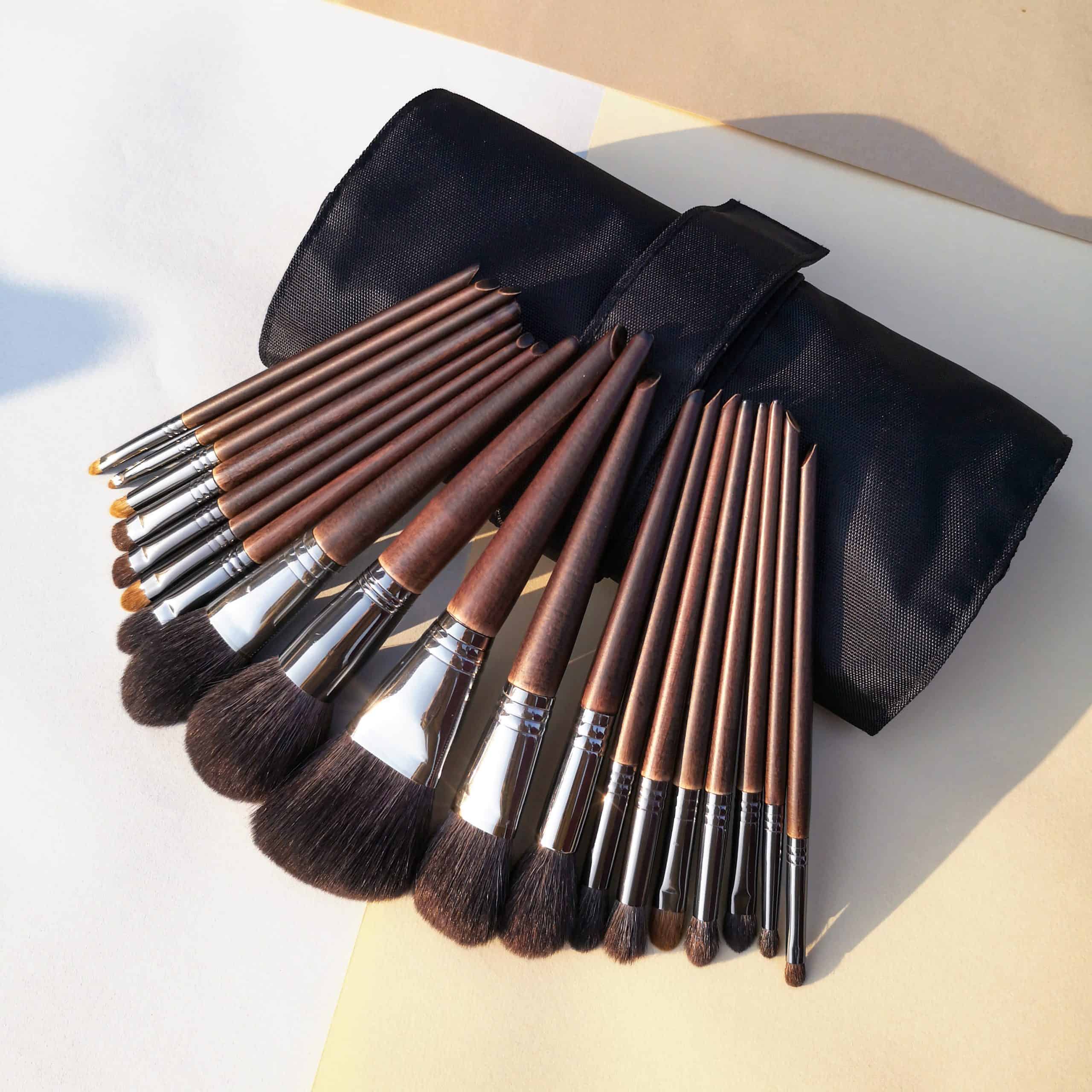 Makeup brushes set in a black travel case on a white and beige background, ideal for beauty salons and professional makeup artists.