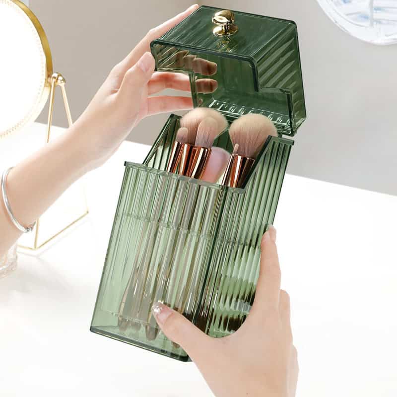 Eco-friendly makeup brush holder and organizer, transparent green acrylic with storage compartments for beauty tools.