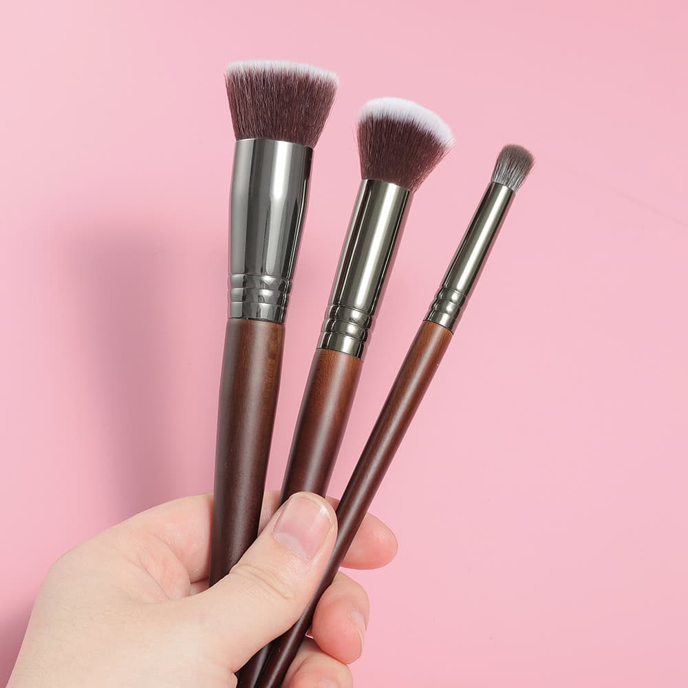 Soft pink makeup brushes set with wooden handles and synthetic bristles for cosmetic application, ideal for beauty enthusiasts and professional makeup artists.