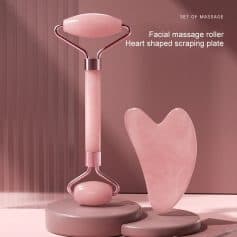 Facial massage roller with heart-shaped scraping plate and pink massage stones, ideal for skin rejuvenation and relaxation.