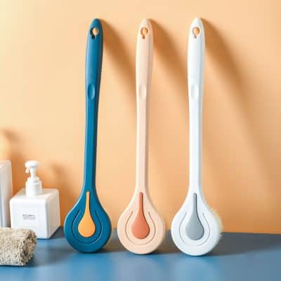 Blue, pink, and white magic eraser cleaning tools on a bathroom shelf for effective cleaning, exfoliating, and removing stains. Perfect for personal care and household cleaning routines.