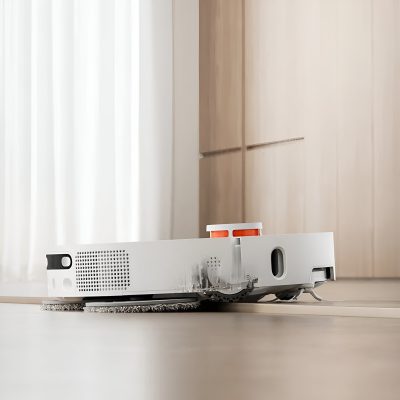 Robotic vacuum cleaner cleaning hardwood floor, modern home, smart cleaning technology, floor maintenance, automated cleaning device, Monalisa Medical store.