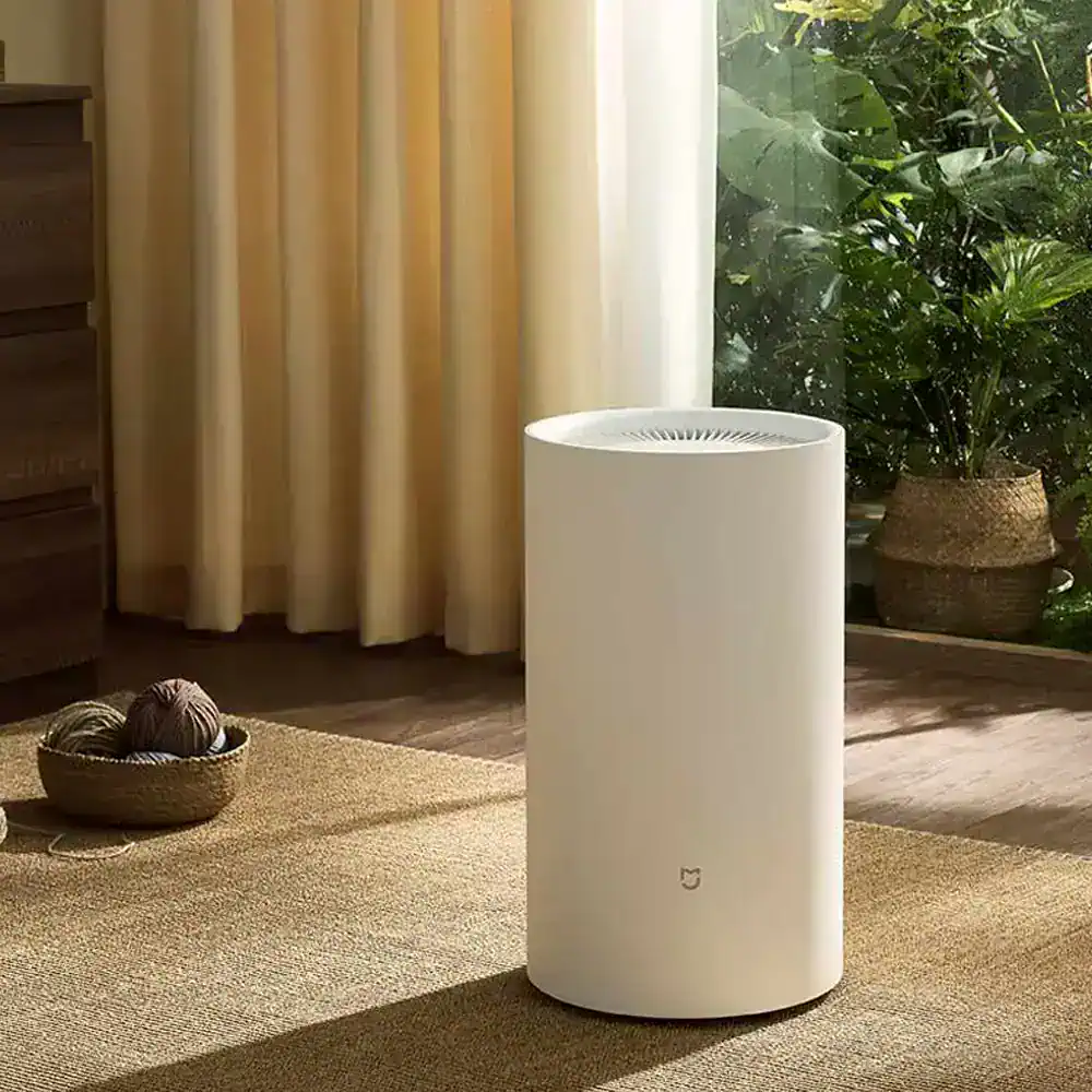 Sleek white Monalisa air purifier in modern home interior with indoor plants and natural light, designed for clean air with smart technology.