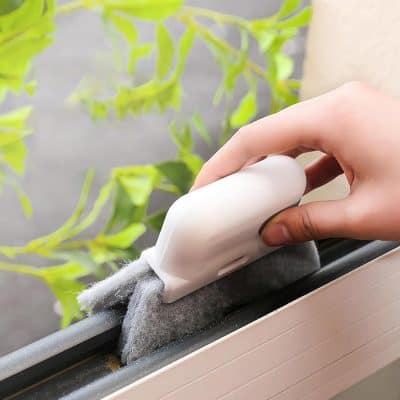 Cleaning window sills with a silicone tool, maintaining cleanliness and hygiene, indoors or outdoors, ideal for home or commercial spaces, using eco-friendly cleaning methods.