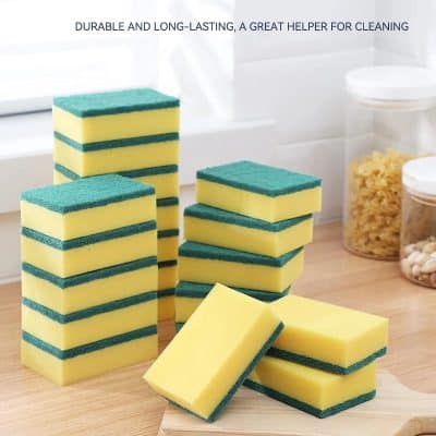 Yellow and green cleaning sponges stacked on a wooden surface in a kitchen setting, highlighting durable and long-lasting kitchen cleaning supplies from Monalisa Store.