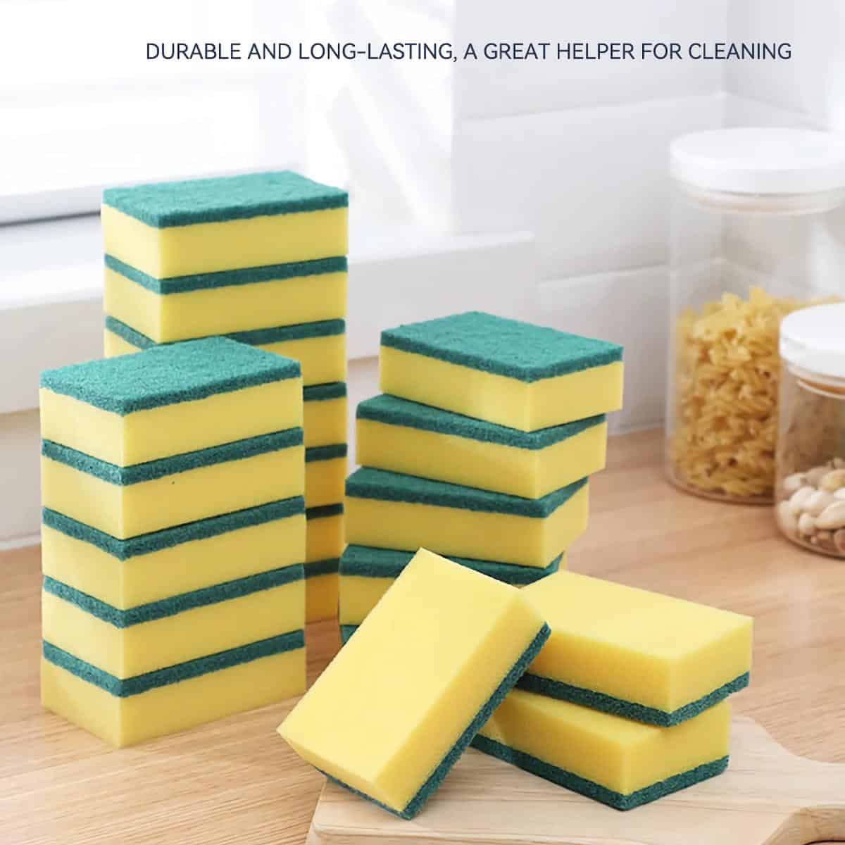 Yellow and green cleaning sponges stacked on a wooden surface in a kitchen setting, highlighting durable and long-lasting kitchen cleaning supplies from Monalisa Store.