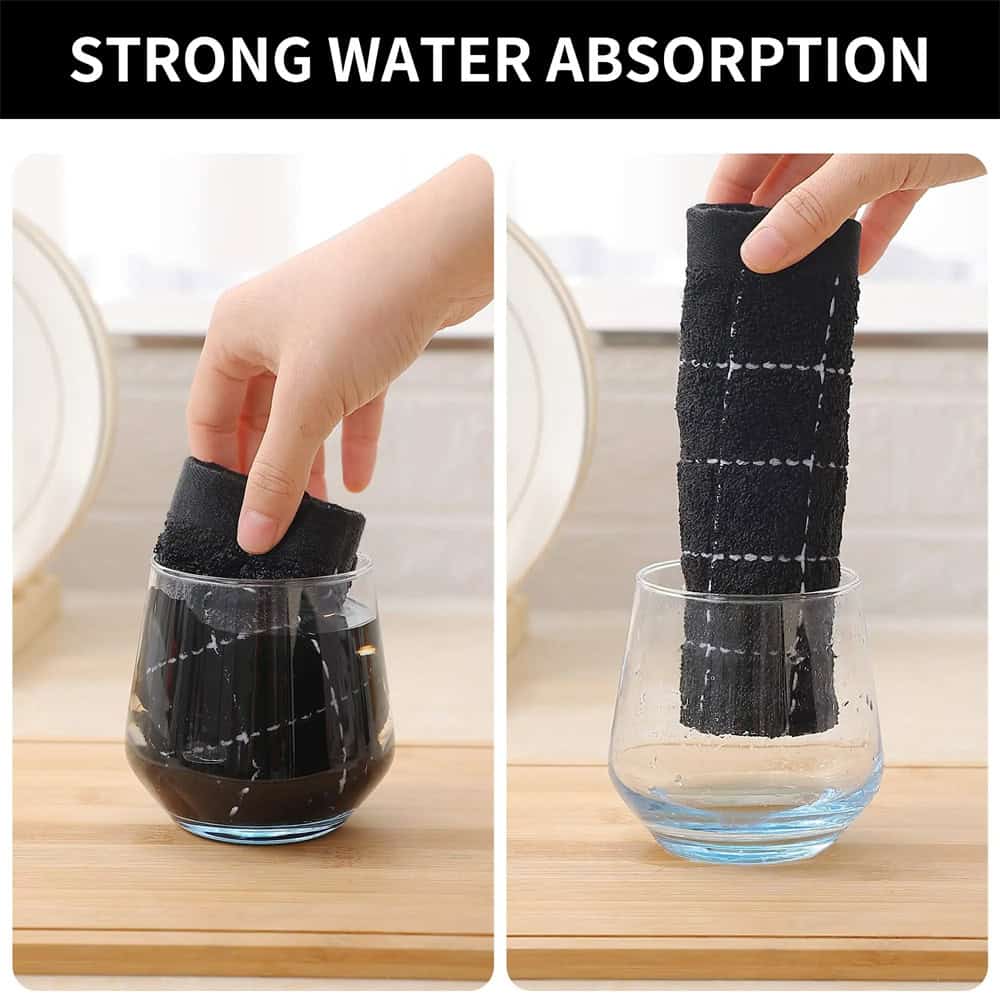 Absorbent black cloth cleaning sponge in glass of water, demonstrating strong water absorption, ideal for kitchen cleaning and household chores.