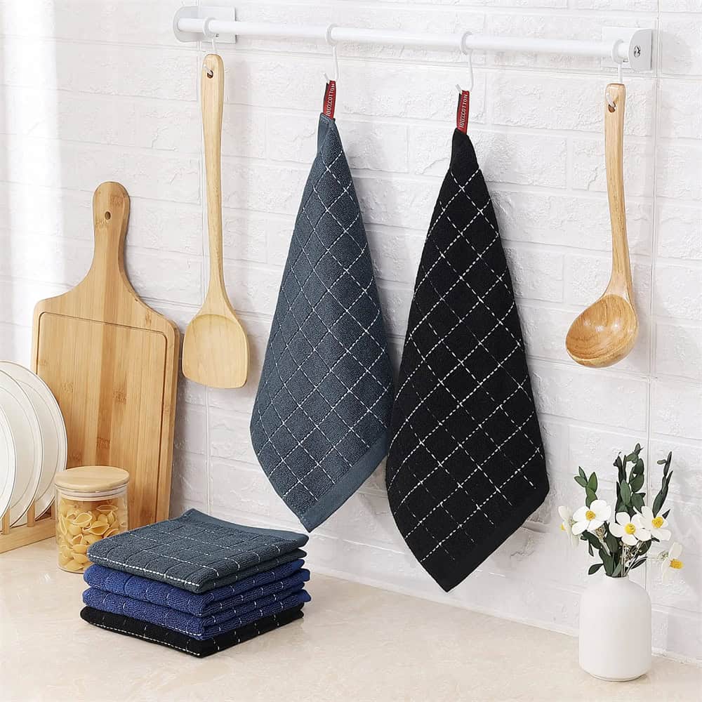 Soft kitchen towels hanging on a rack with wooden utensils, cutting board, and dishware, ideal for home and kitchen decor, emphasizing quality and style.