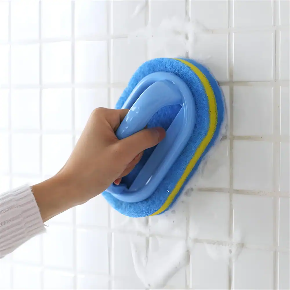 Efficient tile cleaning with a hand-held scrubber and sponge, perfect for maintaining the shine and hygiene of bathroom walls. Ideal for home cleaning and tile maintenance.