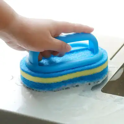 Blue and yellow cleaning sponge with handle for kitchen cleaning and scrubbing tough stains.