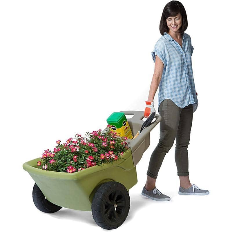 Flower cart with gardening tools and pink flowers, woman in casual clothes, outdoor gardening, flower gardening supplies, Monalisa Store gardening tools and accessories.