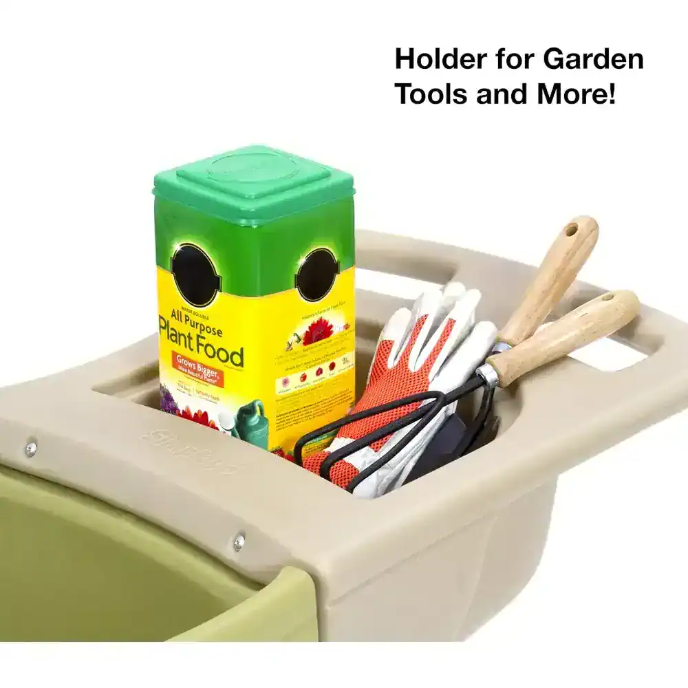 Green plant food fertilizer container with garden tools and gloves in a storage holder for gardening and outdoor plant care.