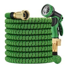Flexible green garden hose with spray nozzle and connectors for outdoor watering.