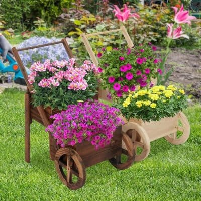 Colorful flower arrangements in wooden carts on a lush garden lawn, perfect for enhancing outdoor spaces and adding vibrant color with seasonal blooms. Ideal for garden decor and floral displays.