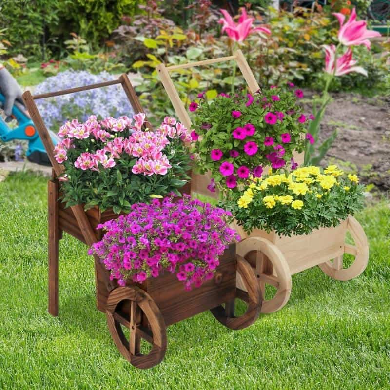 Colorful flower arrangements in wooden carts on a lush garden lawn, perfect for enhancing outdoor spaces and adding vibrant color with seasonal blooms. Ideal for garden decor and floral displays.