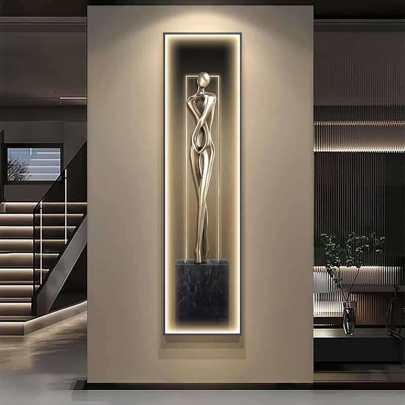 Elegant metallic abstract sculpture displayed on a modern wall with backlit lighting in a luxury interior space. Perfect for enhancing upscale ambiance and stylish decor.
