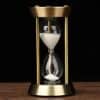 Is a close-up photo of an elegant hourglass showing white sand passing through the middle, symbolizing time and precision for optometry and eye care.