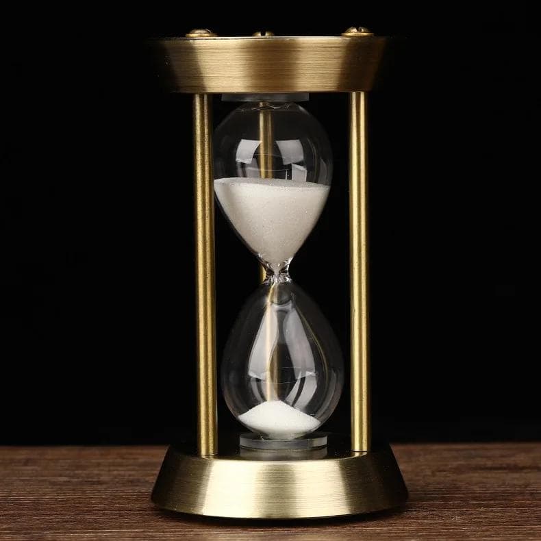 Is a close-up photo of an elegant hourglass showing white sand passing through the middle, symbolizing time and precision for optometry and eye care.