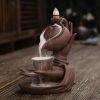 Hands holding a ceramic teapot pouring tea into a small cup, traditional tea set on wooden table, cozy and warm ambiance, Monalisa Medical store focus, aesthetic tea ceremony, elegant pottery art, cultural tea drinking experience.