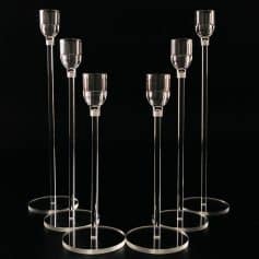 Elevated glass candle holders with sleek design, perfect for elegant home decor or special events.