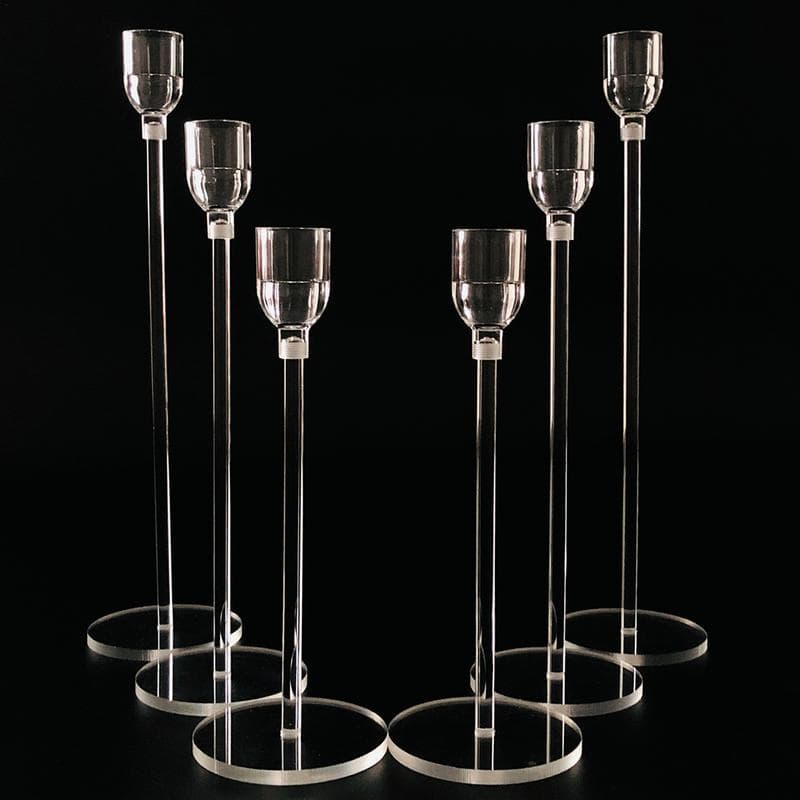 Elevated glass candle holders with sleek design, perfect for elegant home decor or special events.