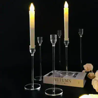 Elegant candle holders with tall candles and glass accents, perfect for creating a luxurious ambiance in home decor or special events.
