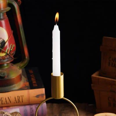 Candle holder with lit candle in a stylish interior, emphasizing elegant home decor and lighting solutions.
