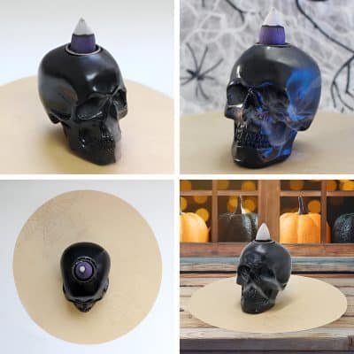 Black skull-shaped wax warmer with purple flame top, Halloween-themed decorative candle holder, perfect for spooky home decor and Halloween parties.