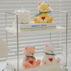 Adorable teddy bear candles with heart and bow details, perfect for home decor or gifts.