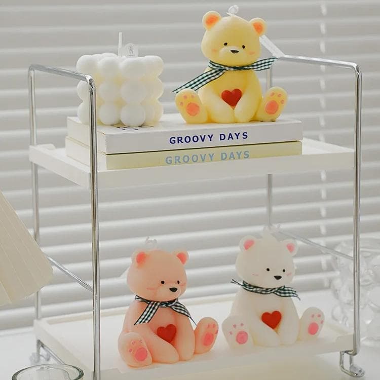 Adorable teddy bear candles with heart and bow details, perfect for home decor or gifts.