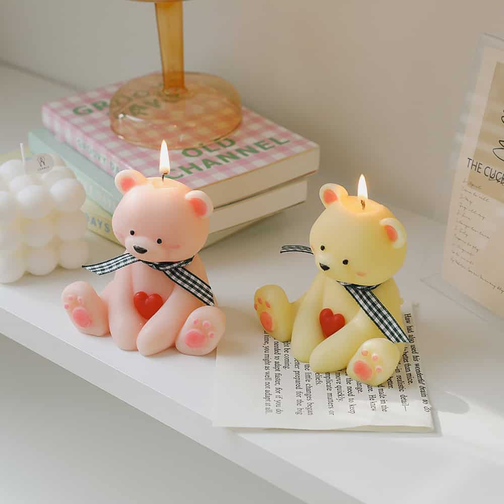Pink and yellow teddy bear-shaped candles with hearts, decorative candles highlighting Monalisa Store's unique collection of gift candles and home decor accessories for a cozy, charming ambiance.
