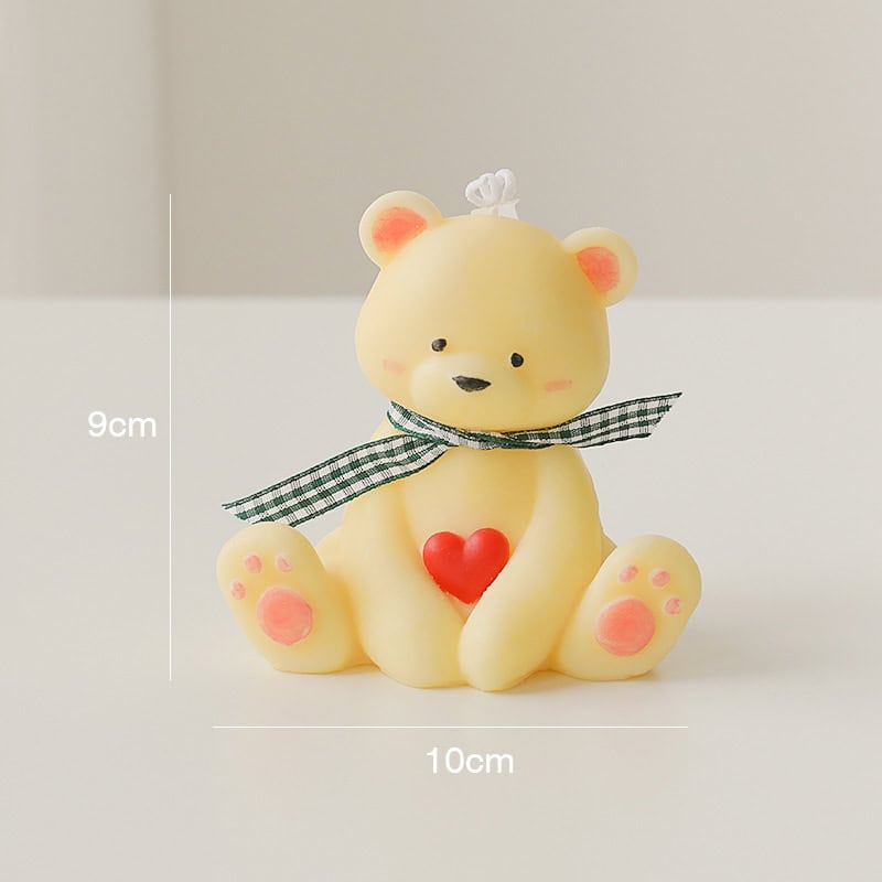 Bear-shaped decorative candle with heart detail, ideal for home decor and gift ideas. Measures 9cm x 10cm, featuring a cute design with a ribbon bow, perfect for creating a cozy and charming atmosphere.