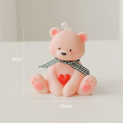 Adorable pink bear figurine with a black-and-white checked ribbon, red heart, and measuring 9cm by 10cm, perfect for decorative purposes or as a gift item for loved ones.