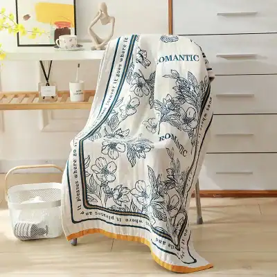 Luxurious floral printed towel draped over a chair, perfect for home decor or spa settings. Features elegant design with “ROMANTIC” text, adding a touch of sophistication to any space.