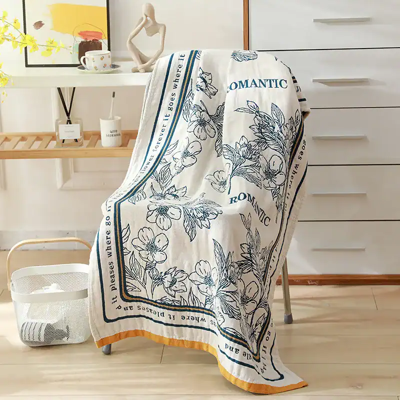 Luxurious floral printed towel draped over a chair, perfect for home decor or spa settings. Features elegant design with “ROMANTIC” text, adding a touch of sophistication to any space.