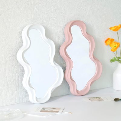 Elegant wavy-shaped mirrors in white and blush pink, ideal for modern interiors, home decor, and vanity setups at Monalisa Store. Perfect for enhancing space aesthetics and style.