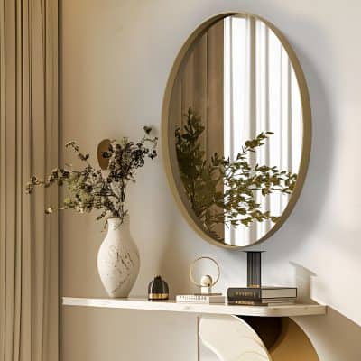 Elegant interior decor featuring a large oval mirror, decorative vases with dried flowers, and stylish accessories on a sleek white console table, creating a luxurious and modern ambiance for Monalisa Store.