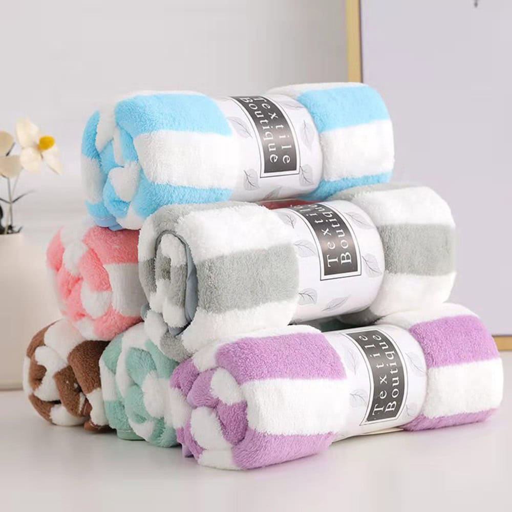Soft, colorful plush towels stacked at Monalisa Store, perfect for luxury bathroom decor, spa, and skincare routines. High-quality, plush, and absorbent towels for a premium home experience.