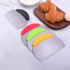 Colorful curved kitchen knives with ergonomic handles on a marble surface, including a stainless steel ruler for precise cutting, perfect for bold, modern kitchen decor and cooking enthusiasts.