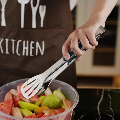 Fresh fruit salad being prepared with tongs, healthy eating, kitchen tools, food preparation, Monalisa Store.