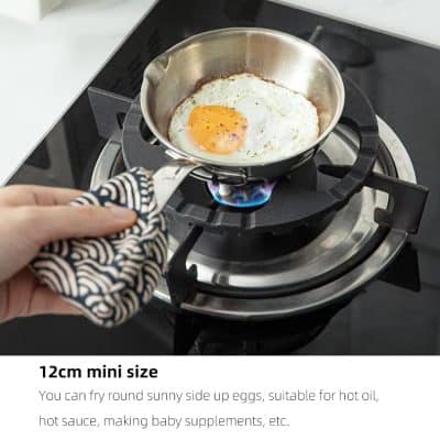 Egg frying pan on gas stove cooking sunny side up eggs with flame visible, suitable for hot oil, sauce, or baby supplements, highlighting compact 12cm mini size features for kitchen and cooking essentials.