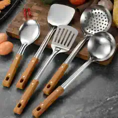 Stainless steel cooking utensils with wooden handles, including spatula, slotted spatula, and ladles, suitable for professional kitchens and home cooking.