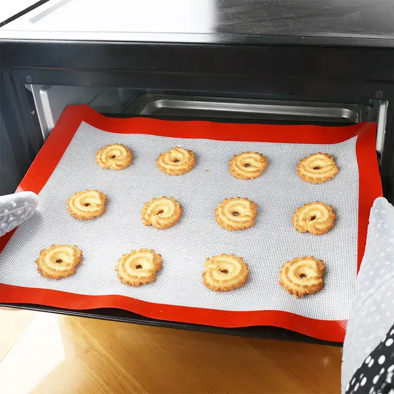 Golden-baked cookies on a silicone baking mat in oven, fresh homemade pastry, energy-efficient baking process, delicious cookie treats, Monalisa Store bakery selection.