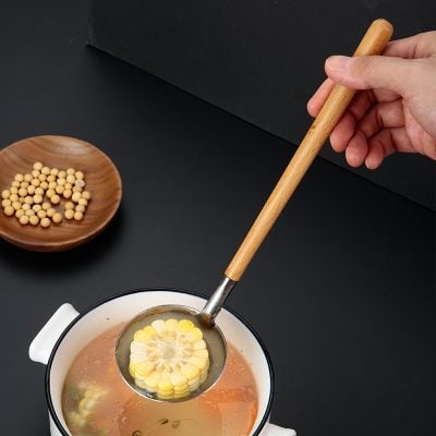 Soup ladle with corn on the cob in hot broth at Monalisa Medical store.